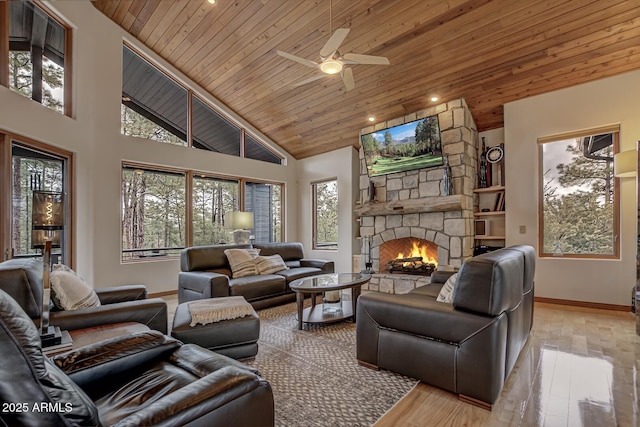 living room with a stone fireplace, hardwood / wood-style flooring, wooden ceiling, and high vaulted ceiling