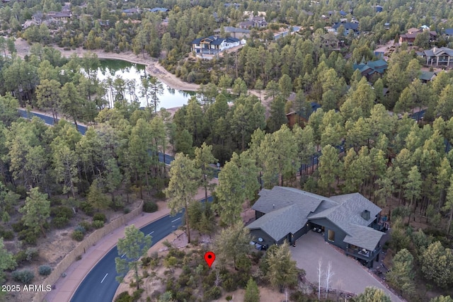 bird's eye view with a residential view, a view of trees, and a water view