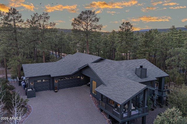 birds eye view of property with a view of trees