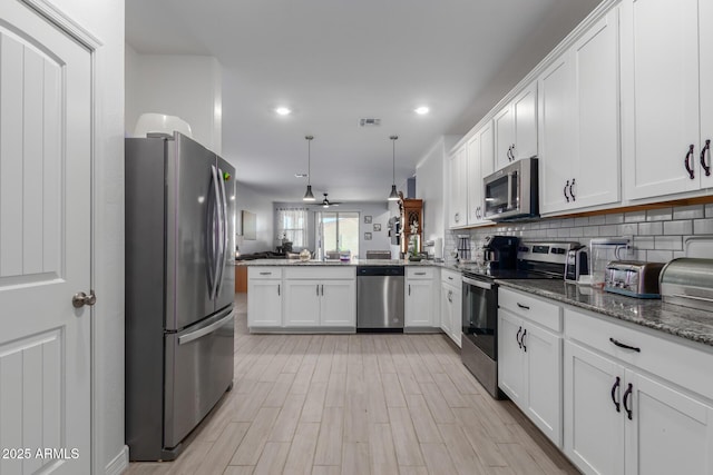 1463 W Pinkley Ave, Coolidge, AZ 85128 - kitchen featuring stainless steel appliances, open floor plan, white cabinets, a peninsula, and recessed lighting