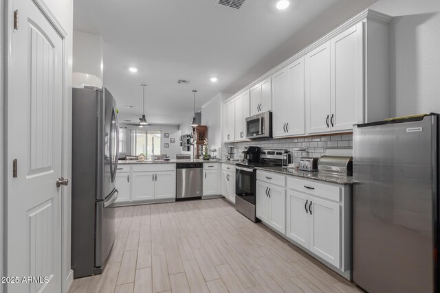 1463 W Pinkley Ave, Coolidge, AZ 85128 - kitchen with appliances with stainless steel finishes, decorative backsplash, white cabinetry, recessed lighting, and stone countertops