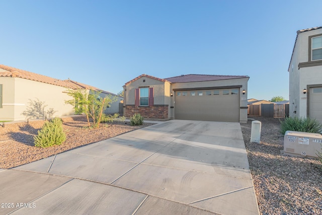 1463 W Pinkley Ave, Coolidge, AZ 85128 - view of front of home with concrete driveway, stucco siding, an attached garage, a tiled roof, and stone siding