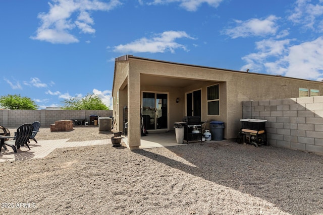 1463 W Pinkley Ave, Coolidge, AZ 85128 - back of house with a fenced backyard, a patio, stucco siding, and a fire pit