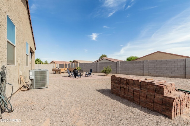 1463 W Pinkley Ave, Coolidge, AZ 85128 - fenced backyard with central air condition unit, an outdoor fire pit, and a patio