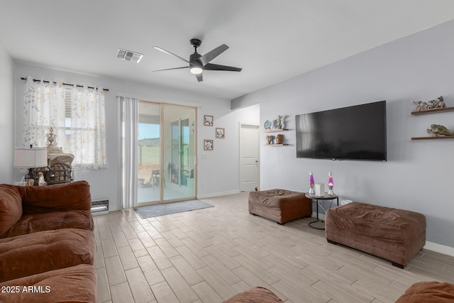 1463 W Pinkley Ave, Coolidge, AZ 85128 - living room with ceiling fan, light wood-type flooring, and baseboards