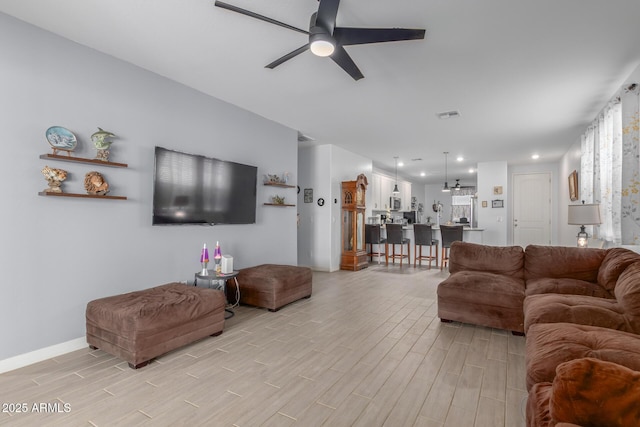 1463 W Pinkley Ave, Coolidge, AZ 85128 - living room with light wood finished floors, a ceiling fan, baseboards, and recessed lighting