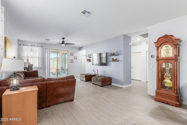 1463 W Pinkley Ave, Coolidge, AZ 85128 - living area with light wood finished floors, a ceiling fan, and baseboards