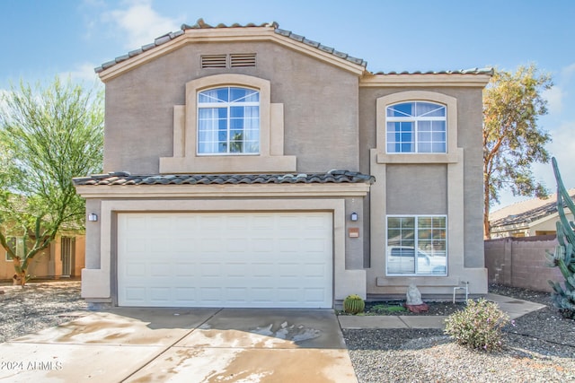 mediterranean / spanish-style house featuring a garage