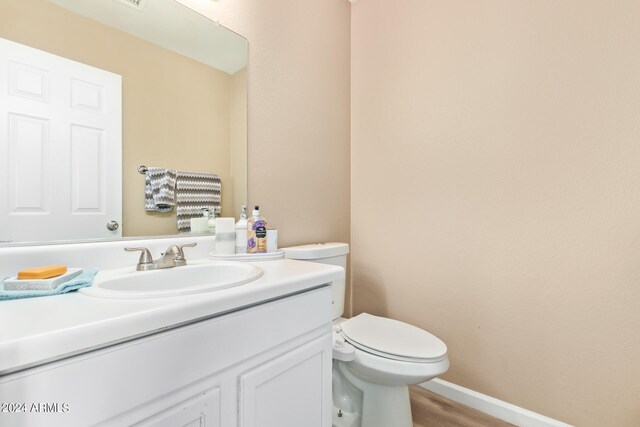 bathroom featuring hardwood / wood-style floors, toilet, and vanity