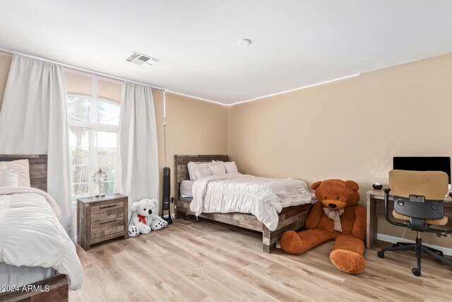 bedroom with light hardwood / wood-style flooring