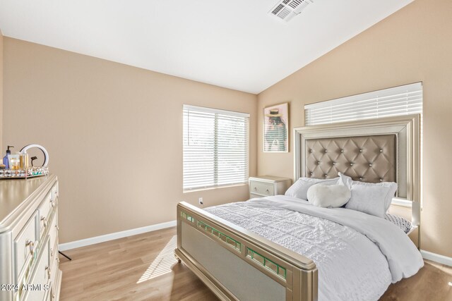 bedroom featuring lofted ceiling and light hardwood / wood-style flooring