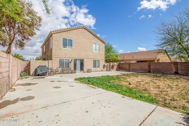 rear view of property featuring a patio