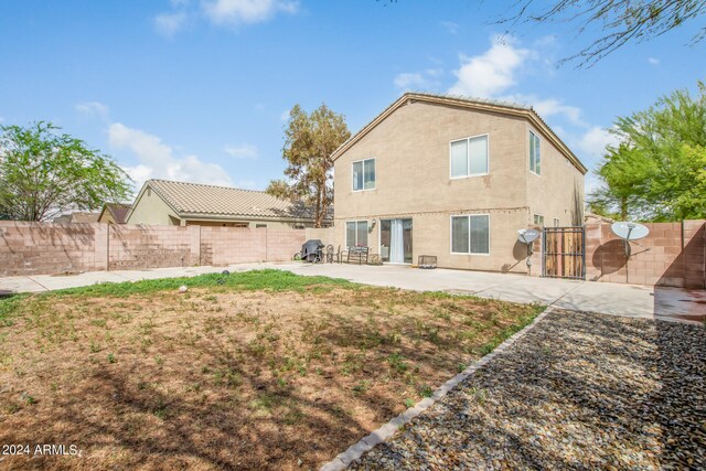 rear view of property featuring a patio area