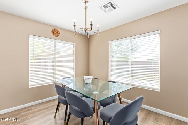 dining room featuring an inviting chandelier and light wood-type flooring