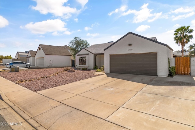 19039 N 47th Ave, Glendale, AZ 85308 - view of front of home with stucco siding, driveway, a garage, and fence