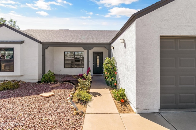 19039 N 47th Ave, Glendale, AZ 85308 - doorway to property with a shingled roof, stucco siding, an attached garage, and a porch