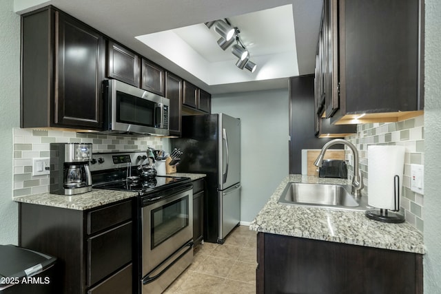 kitchen featuring a sink, light countertops, tasteful backsplash, and stainless steel appliances