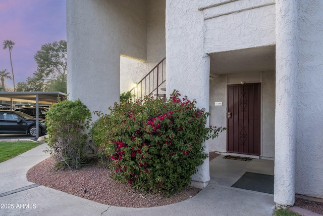 entrance to property with stucco siding