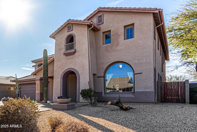 mediterranean / spanish home featuring a garage