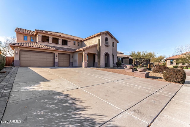 mediterranean / spanish-style house with a garage