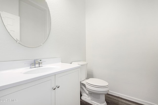 bathroom featuring vanity, toilet, and hardwood / wood-style floors