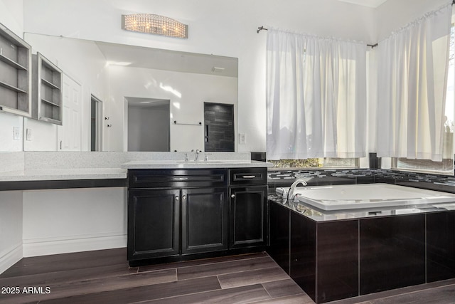 bathroom featuring vanity, wood-type flooring, and tiled bath