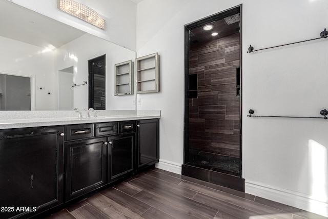 bathroom with vanity and tiled shower