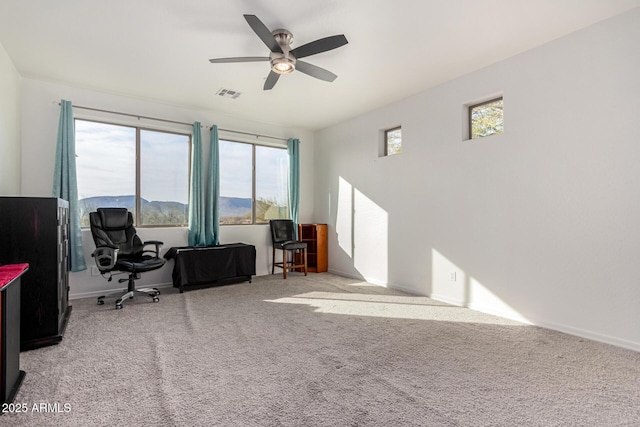 home office featuring light carpet and ceiling fan