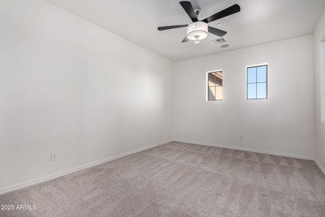 carpeted spare room featuring ceiling fan