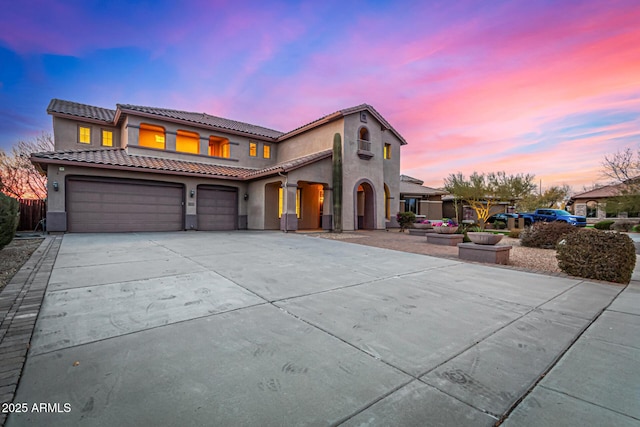 mediterranean / spanish-style home with a garage