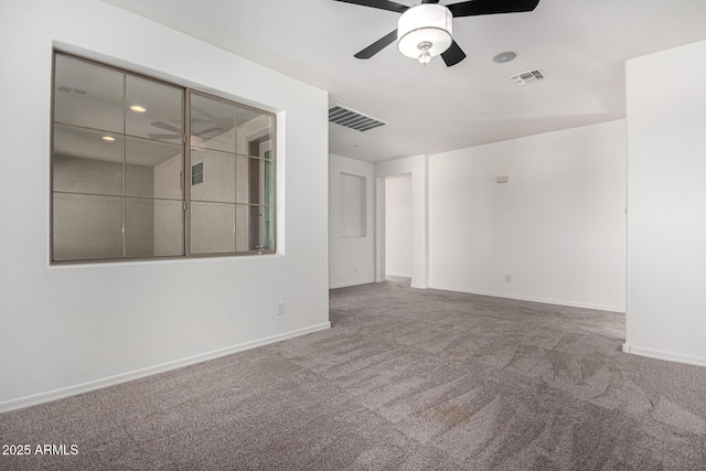 carpeted empty room featuring ceiling fan