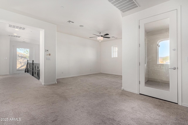 carpeted empty room featuring ceiling fan