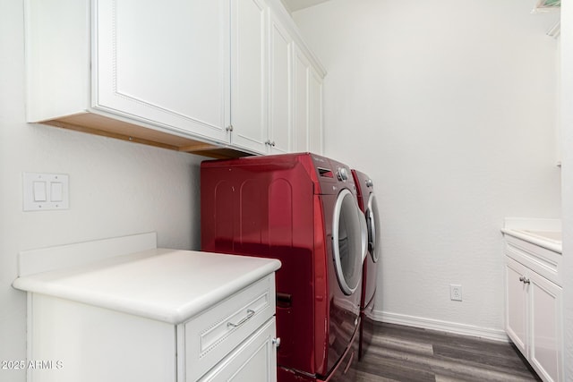 washroom with cabinets, washer and dryer, and dark hardwood / wood-style flooring