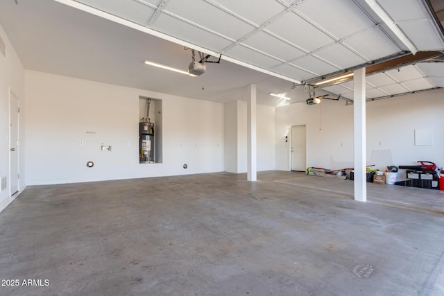 garage with a garage door opener and gas water heater