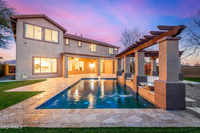 pool at dusk featuring a pergola, a patio area, and pool water feature