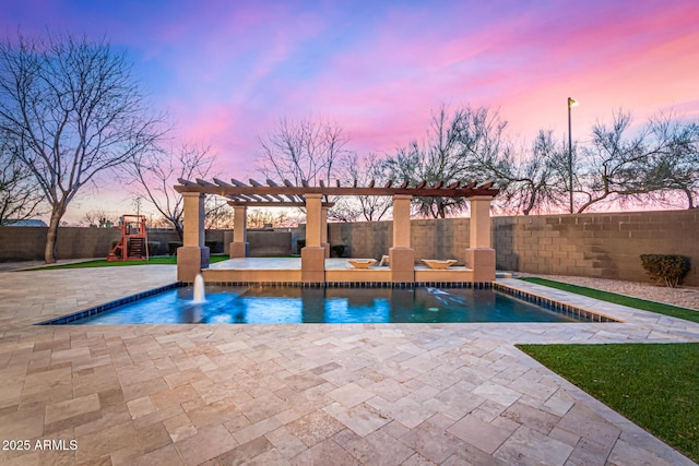 pool at dusk with a playground, a patio, pool water feature, and a pergola