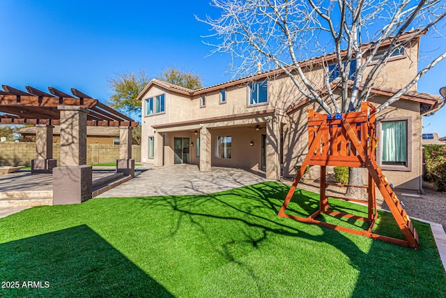 back of house with a yard, a pergola, and a patio area