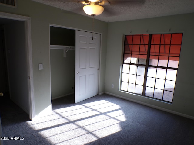 5323 W N Ln, Glendale, AZ 85302 - unfurnished bedroom featuring a textured ceiling, carpet, a closet, and a ceiling fan