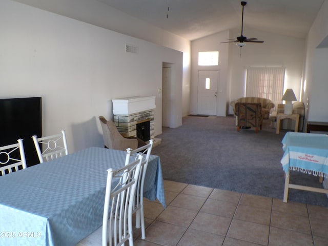 5323 W N Ln, Glendale, AZ 85302 - dining room featuring light colored carpet, ceiling fan, vaulted ceiling, light tile patterned floors, and a fireplace
