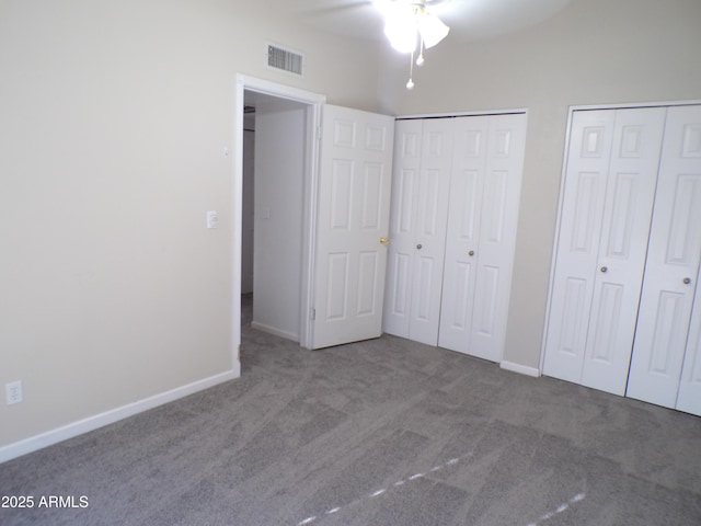 5323 W N Ln, Glendale, AZ 85302 - unfurnished bedroom featuring carpet, two closets, and a ceiling fan