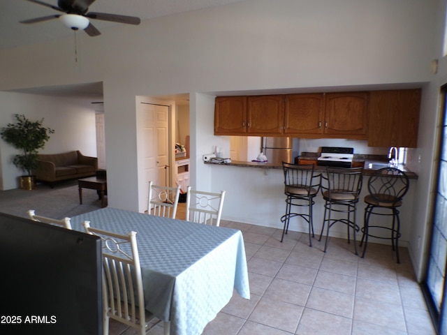 5323 W N Ln, Glendale, AZ 85302 - dining room featuring a ceiling fan, light tile patterned floors, and a towering ceiling
