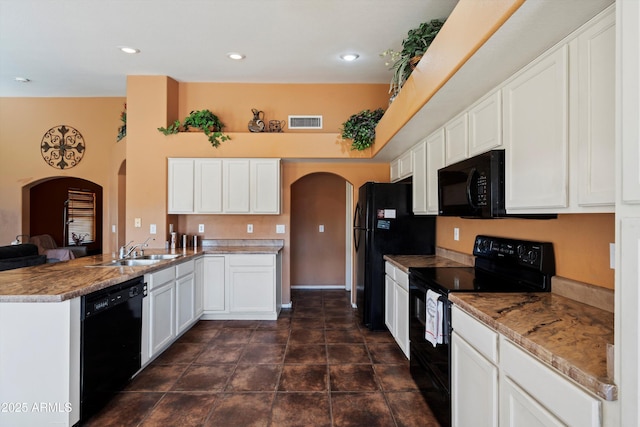 kitchen featuring black appliances, kitchen peninsula, sink, light stone counters, and white cabinetry