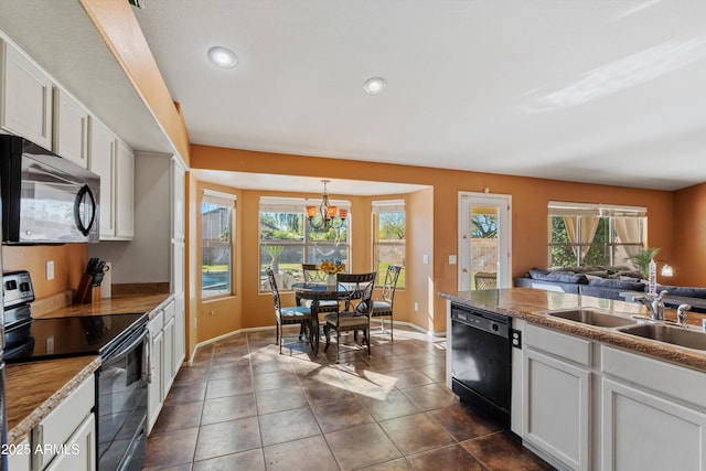 kitchen with white cabinets, sink, a healthy amount of sunlight, and black appliances