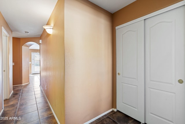 hallway featuring dark tile patterned flooring