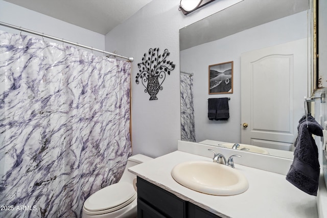 bathroom with vanity, toilet, and curtained shower