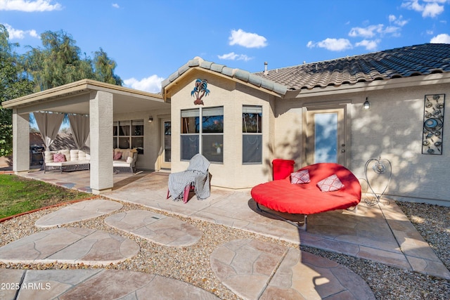 back of house with an outdoor hangout area and a patio