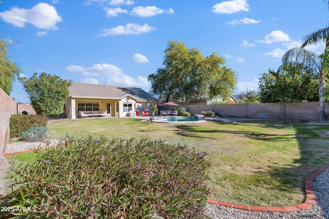 view of yard featuring a fenced in pool and a patio