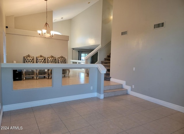 staircase featuring visible vents, baseboards, a chandelier, and tile patterned flooring