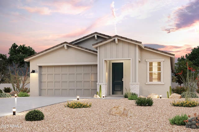 view of front facade with a garage, brick siding, board and batten siding, and driveway