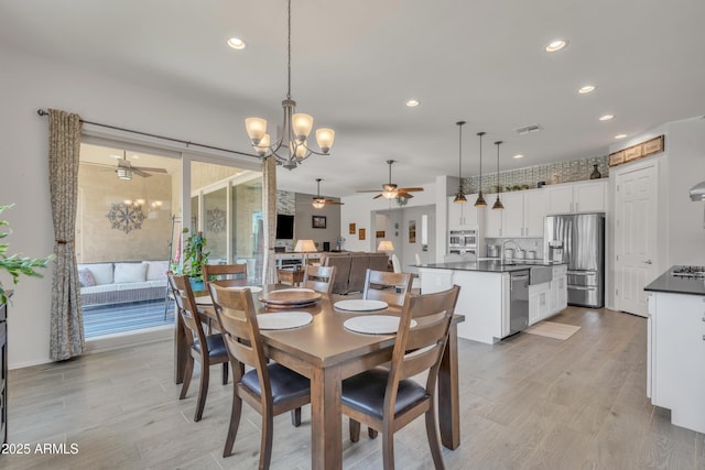 22927 E Via Del Oro, Queen Creek, AZ 85142 - dining space with a ceiling fan, light wood-type flooring, recessed lighting, and a chandelier